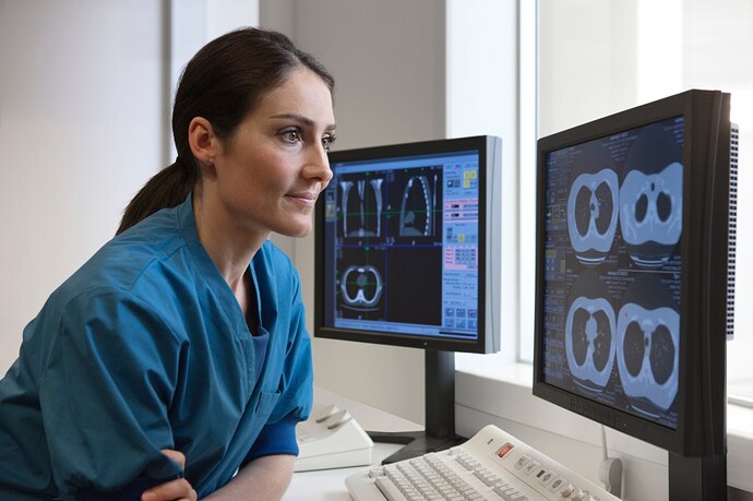 Image 4: Doctor looking at x-rays from CT-scanner on computer